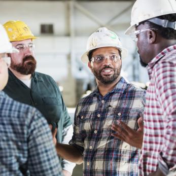 Factory workers having a meeting